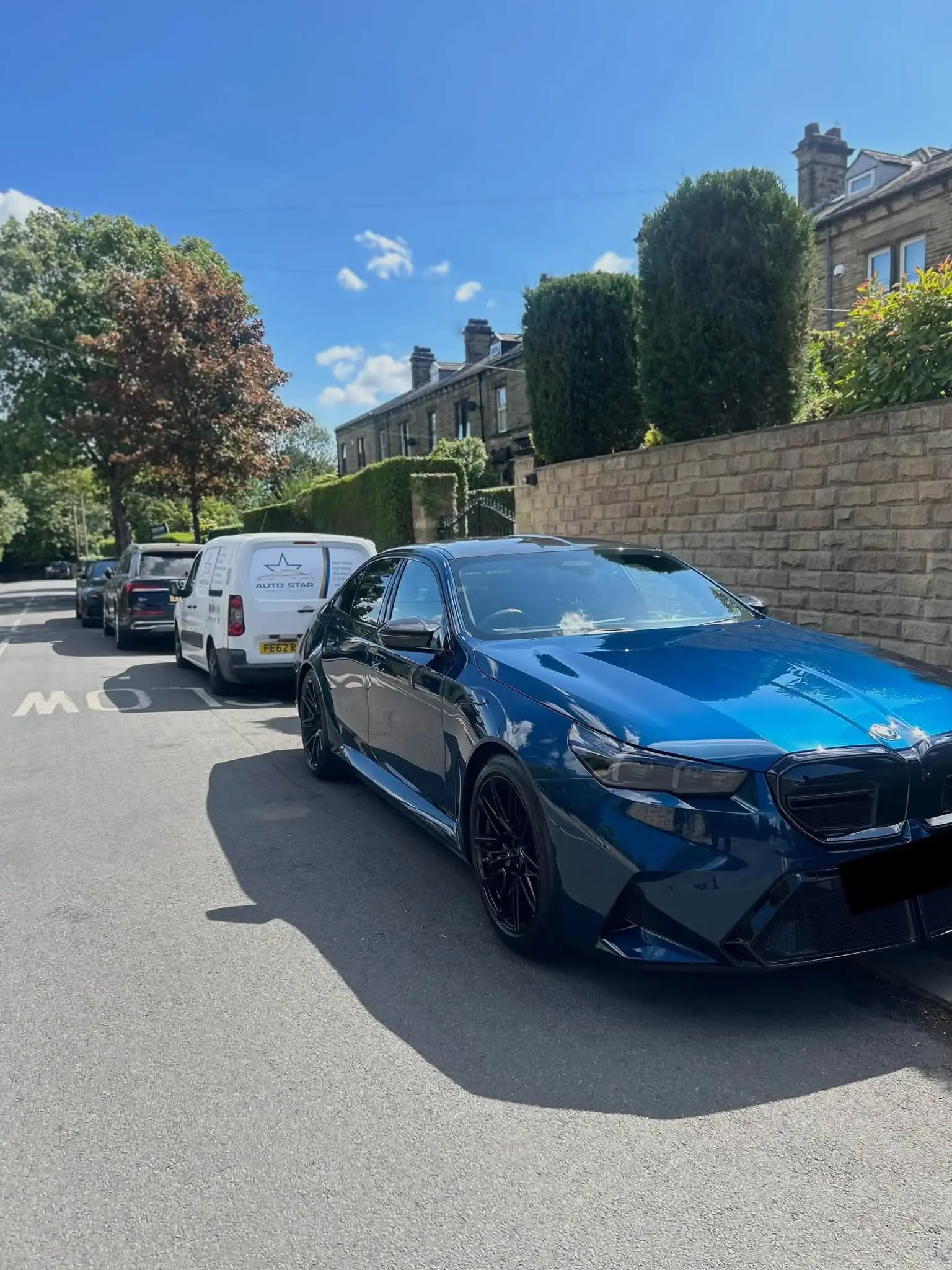 Blue BMW with a reflective paint finish