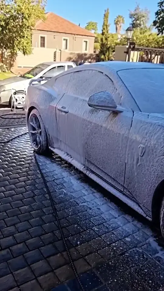 Ford Mustang covered in snow foam during an exterior wash